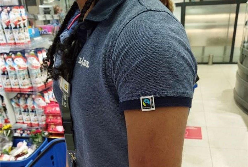 person wearing Lidl uniform with Fairtrade logo on the sleeve